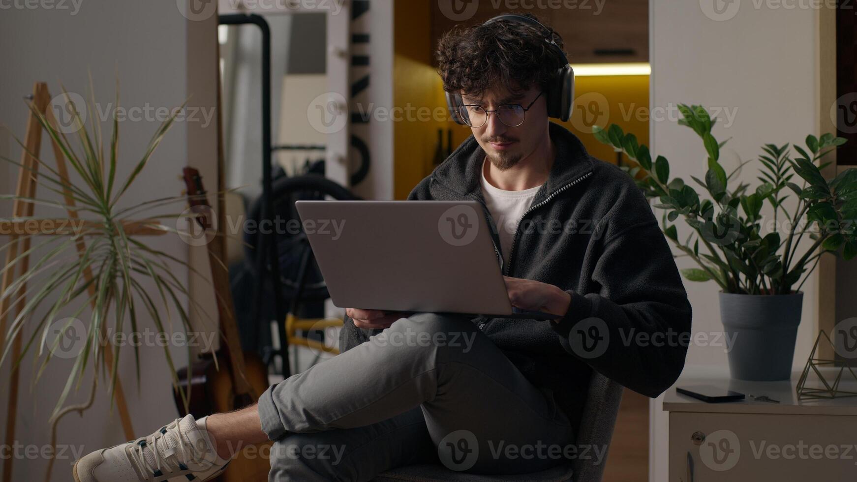 Focused Hispanic guy hipster user holding laptop purchasing delivery at home freelancer developer type man trader search information online Internet male work remote computer tech shopping cyberspace photo