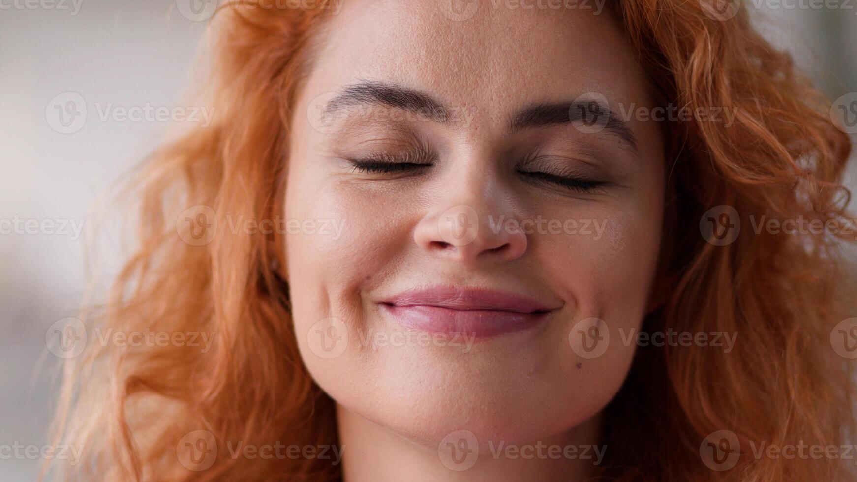 Close up face portrait happy smiling positive dreaming woman closed eyes wish dream carefree smile healthy ginger hair Caucasian female girl homeowner at home think satisfied medicine loan mortgage photo