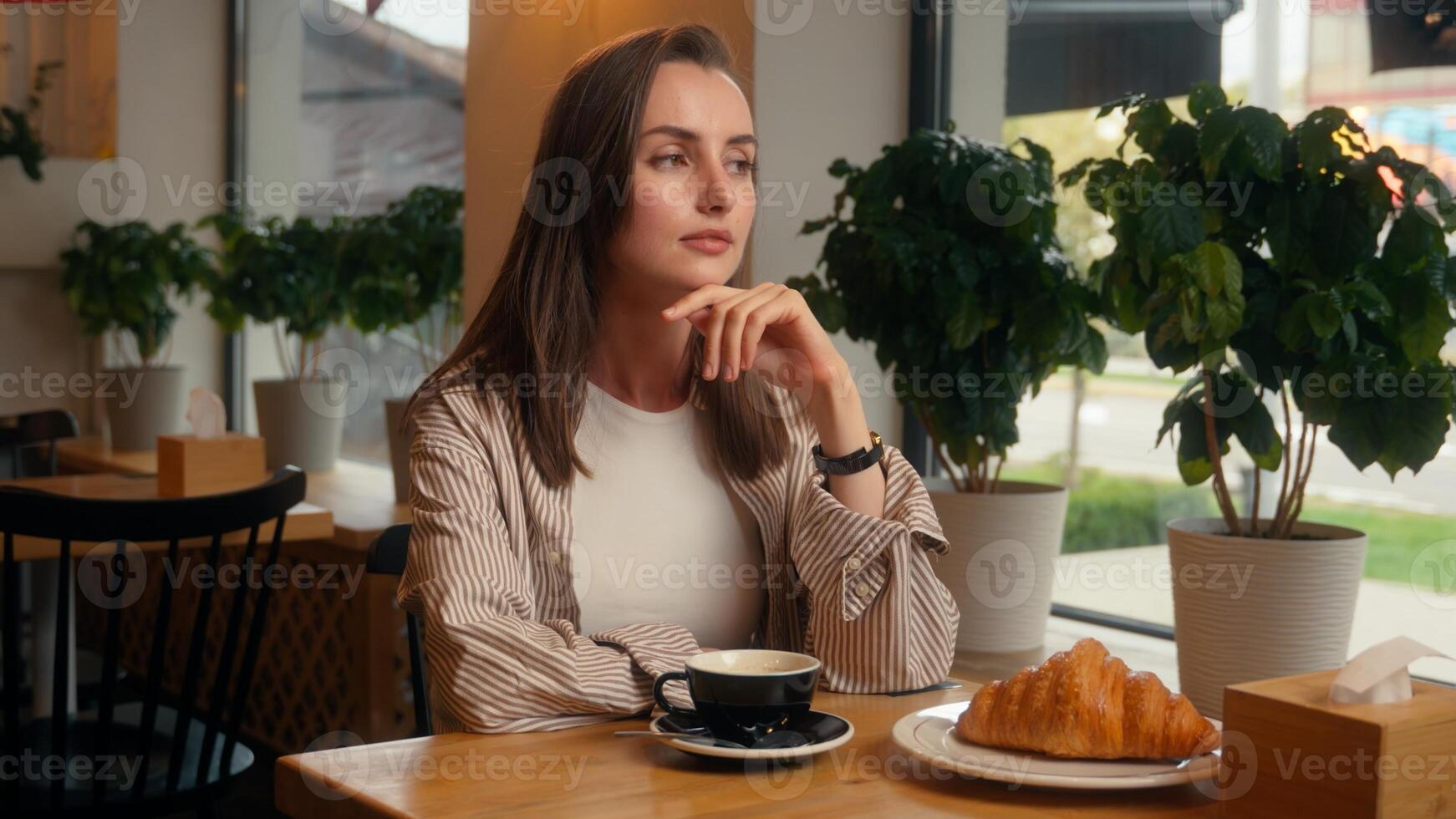 Caucasian woman visitor in cafe wearing wristwatch late time business meeting looking in window waiting date lonely girl female at cafeteria table worry wait impatient lateness upset frustrated lady photo