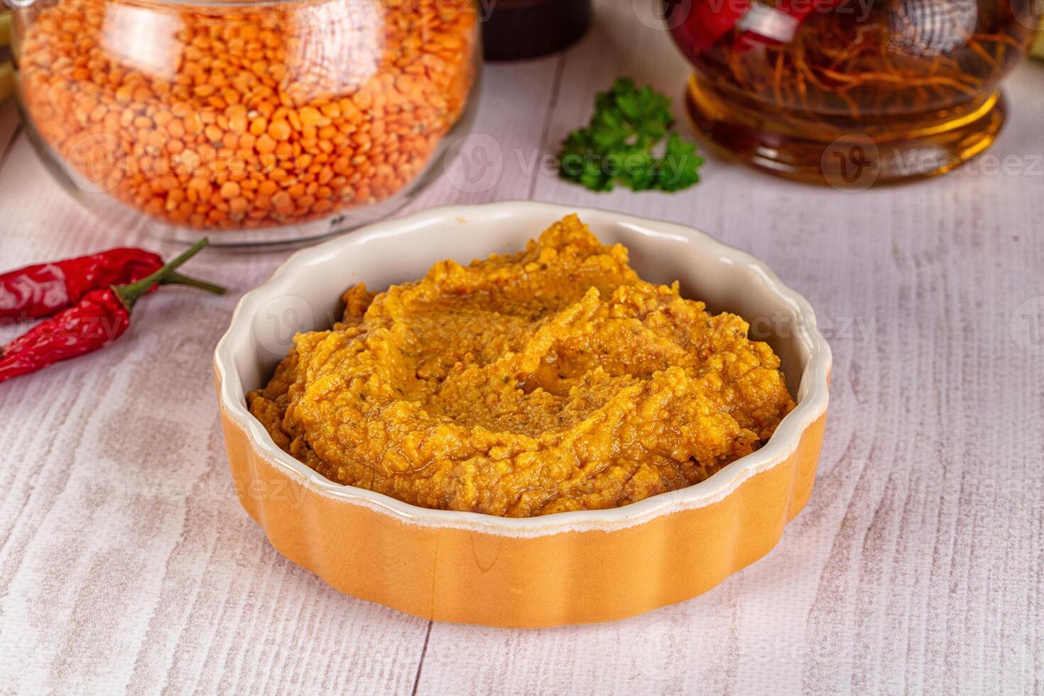 A bowl of brown lentils with spices and other ingredients photo