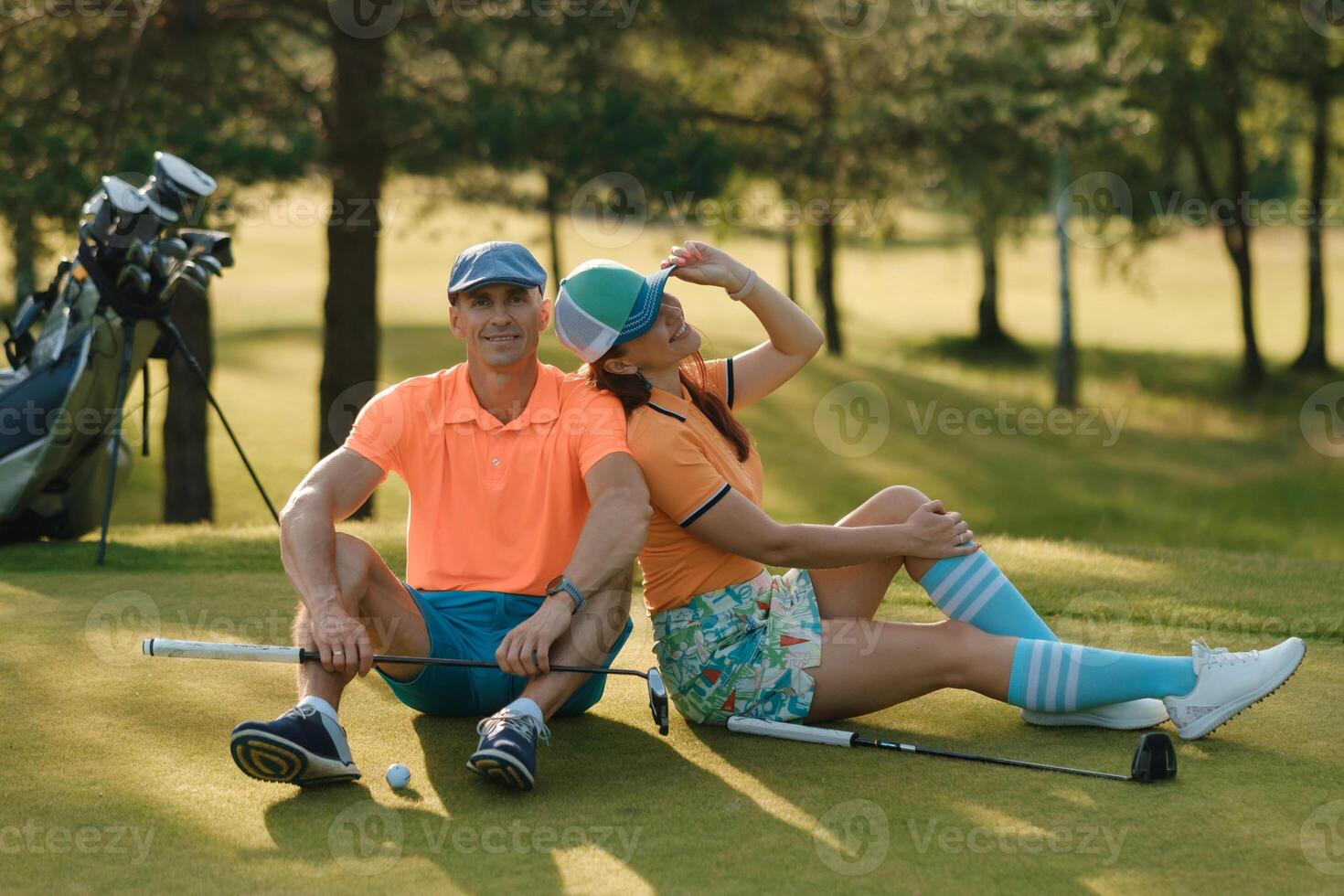 Couple enjoys a relaxing moment on the golf course in sunny weather while playing golf and savoring quality time together photo