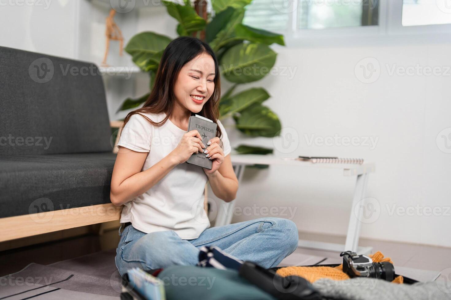 Excited Travel Preparations. Woman smiling while holding travel documents. photo