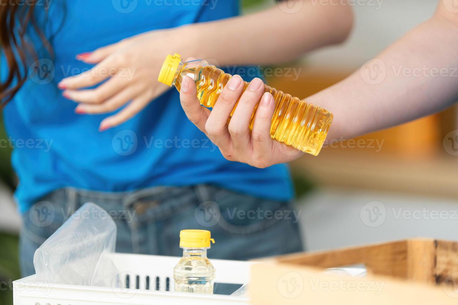 Donation and Food Sharing. Volunteer holding cooking oil for community food drive. photo