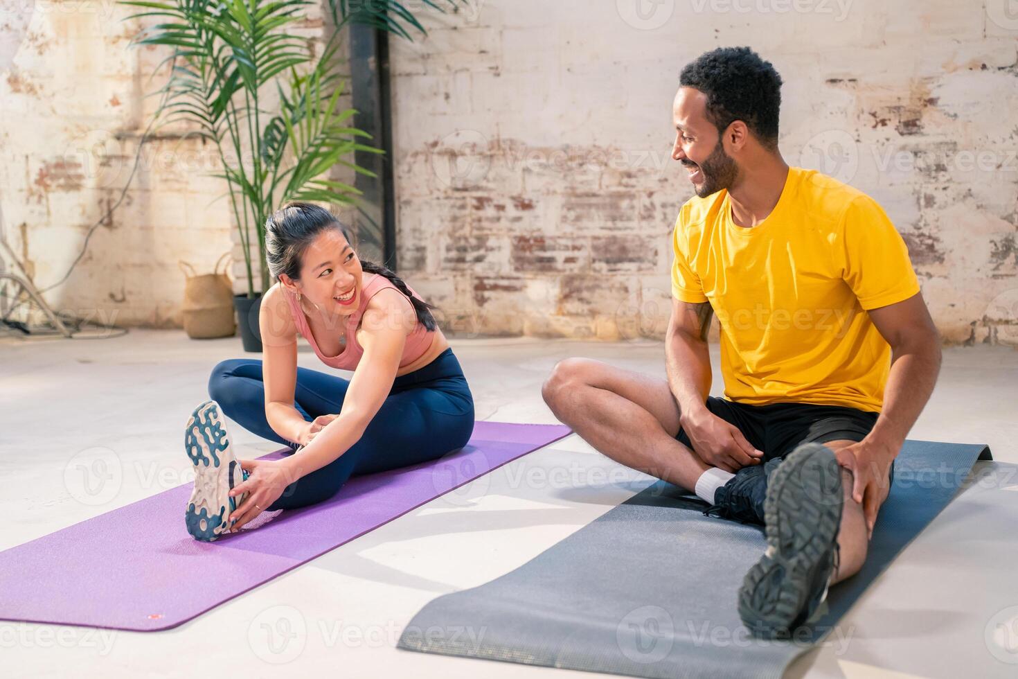 Couple stretching on exercise mats photo