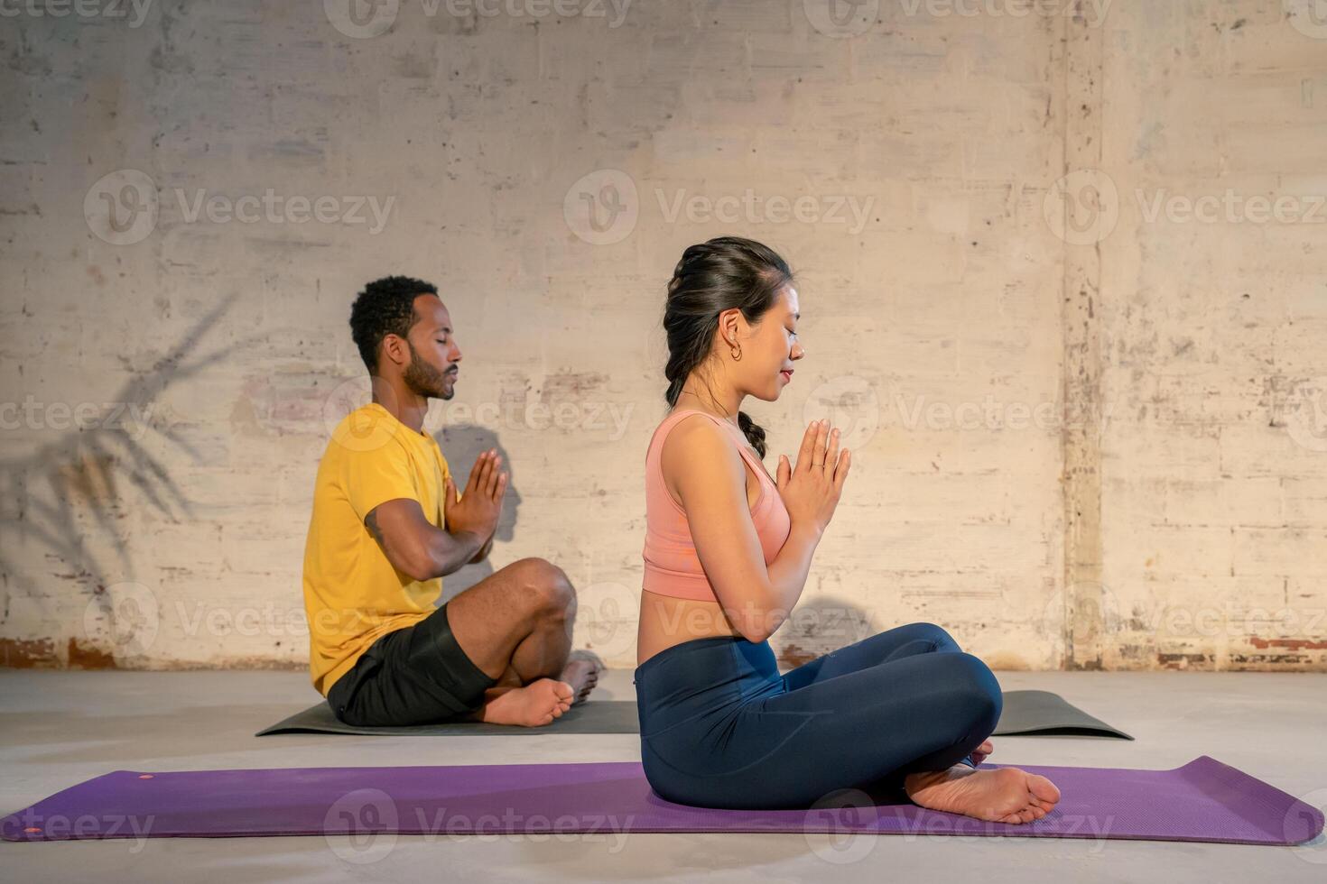 Yoga practitioners meditating on mats photo