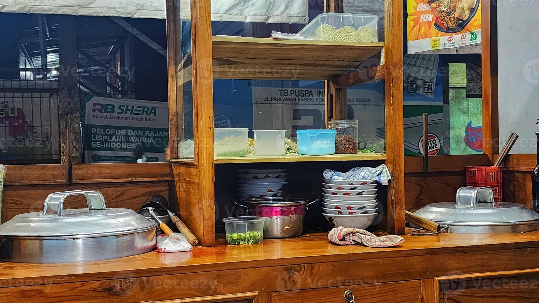 Food stall with wooden counter and food preparation area photo