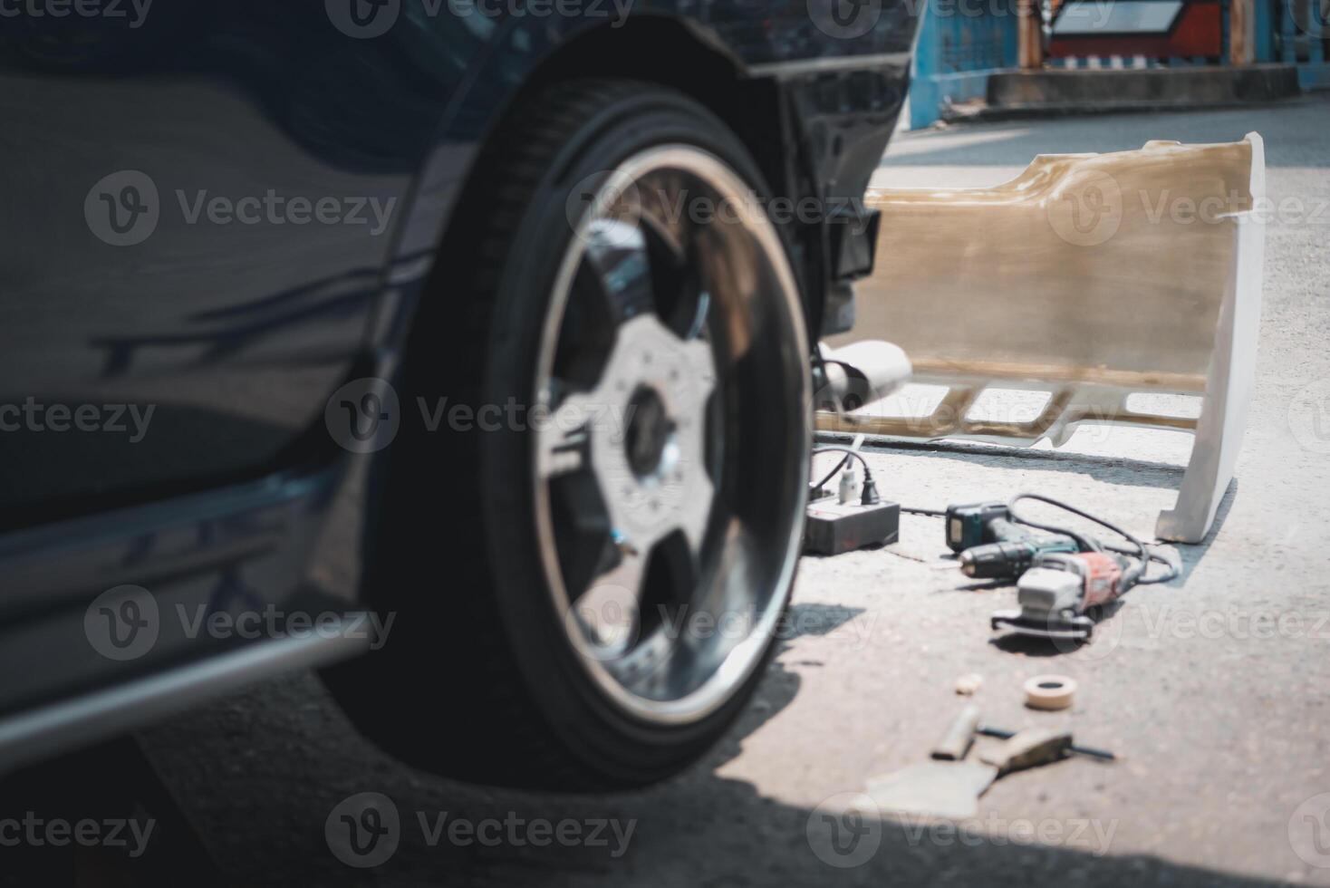 A car with a tire repair kit on the ground photo