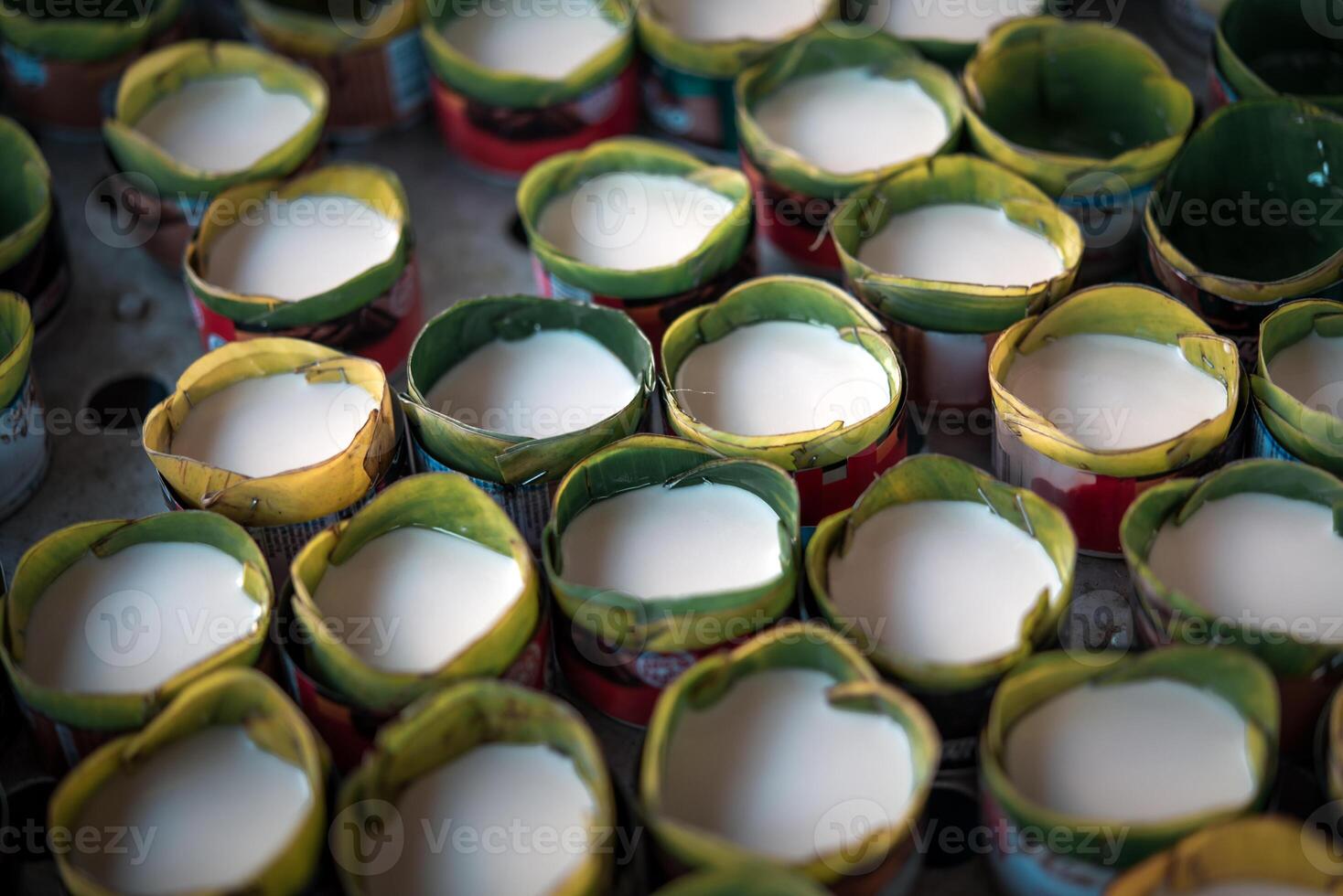 Many small cups filled with milk photo
