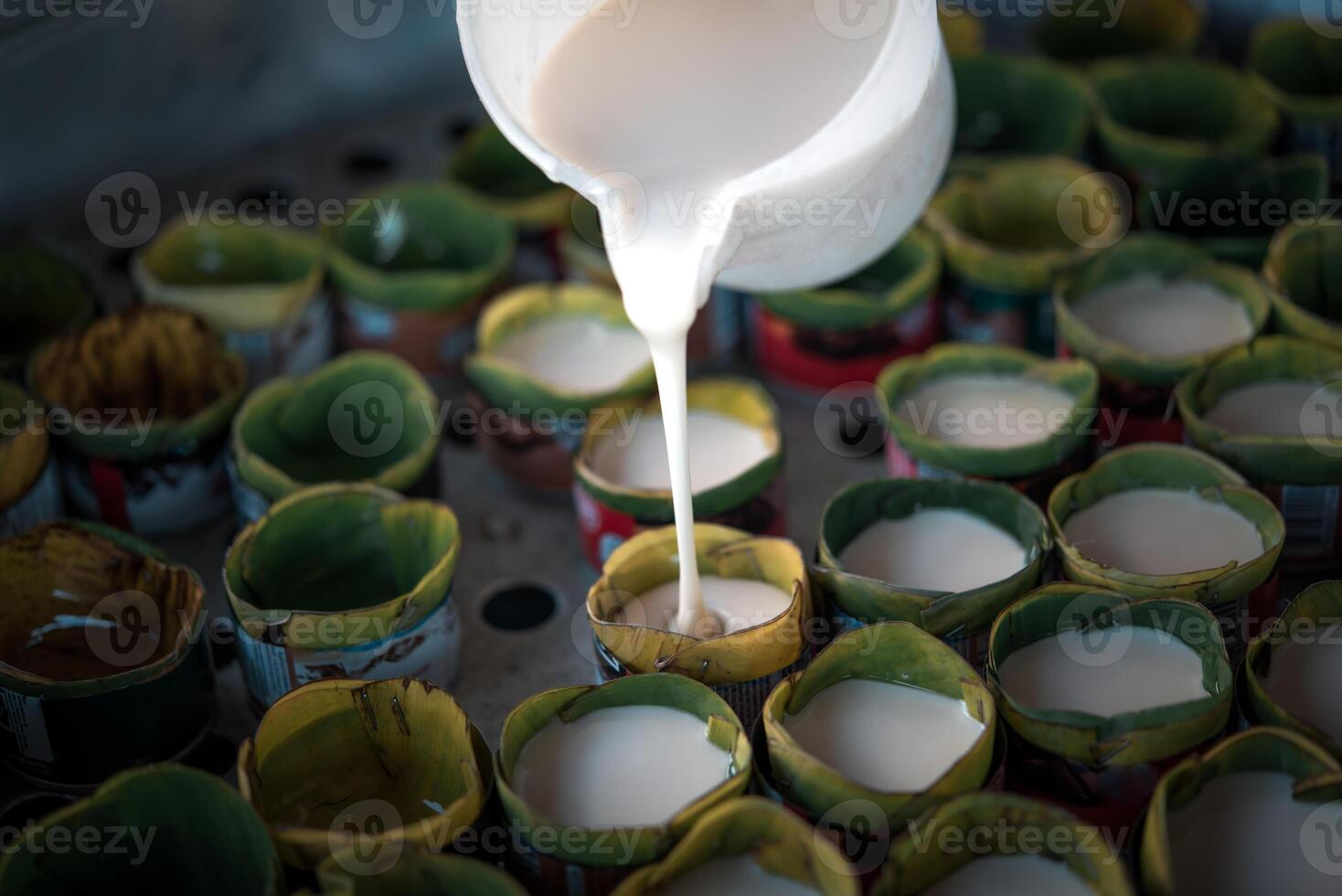 A person pouring milk into a container photo
