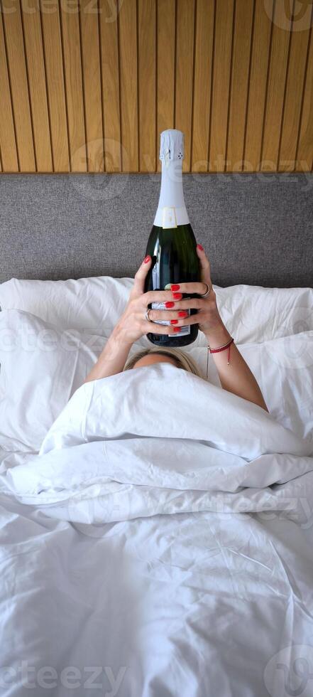 Champagne in bed. Festive morning. photo