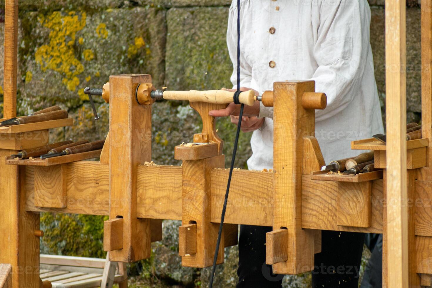 an artisan carpenter working in the traditional style at a historical reenactment party in Galicia photo