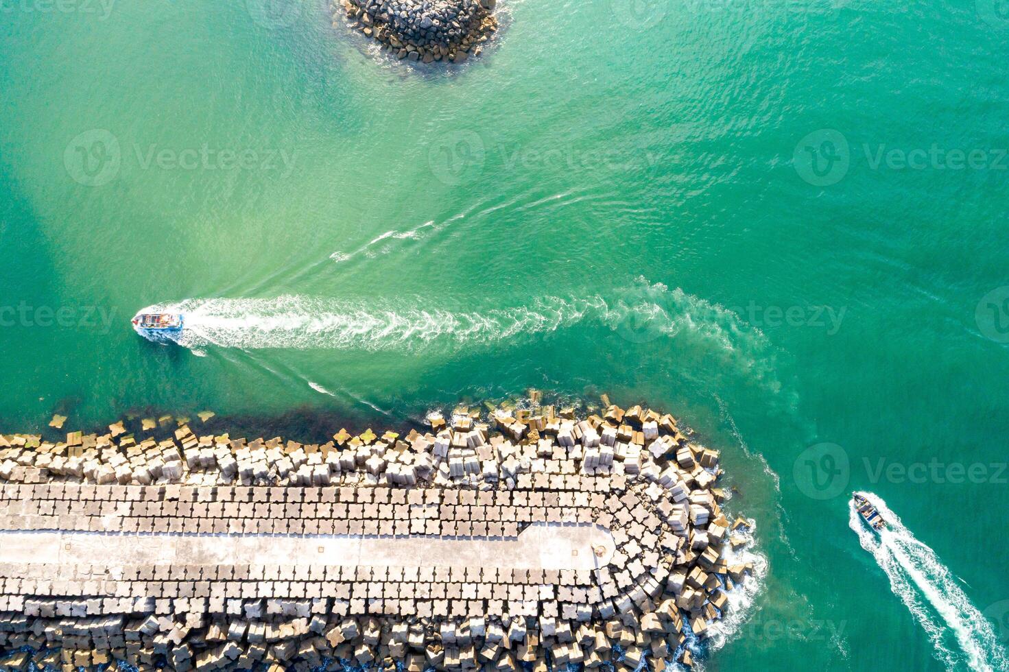 Aerial drone top down View of a Harbor Port Entrance Channel, two boats sailing photo