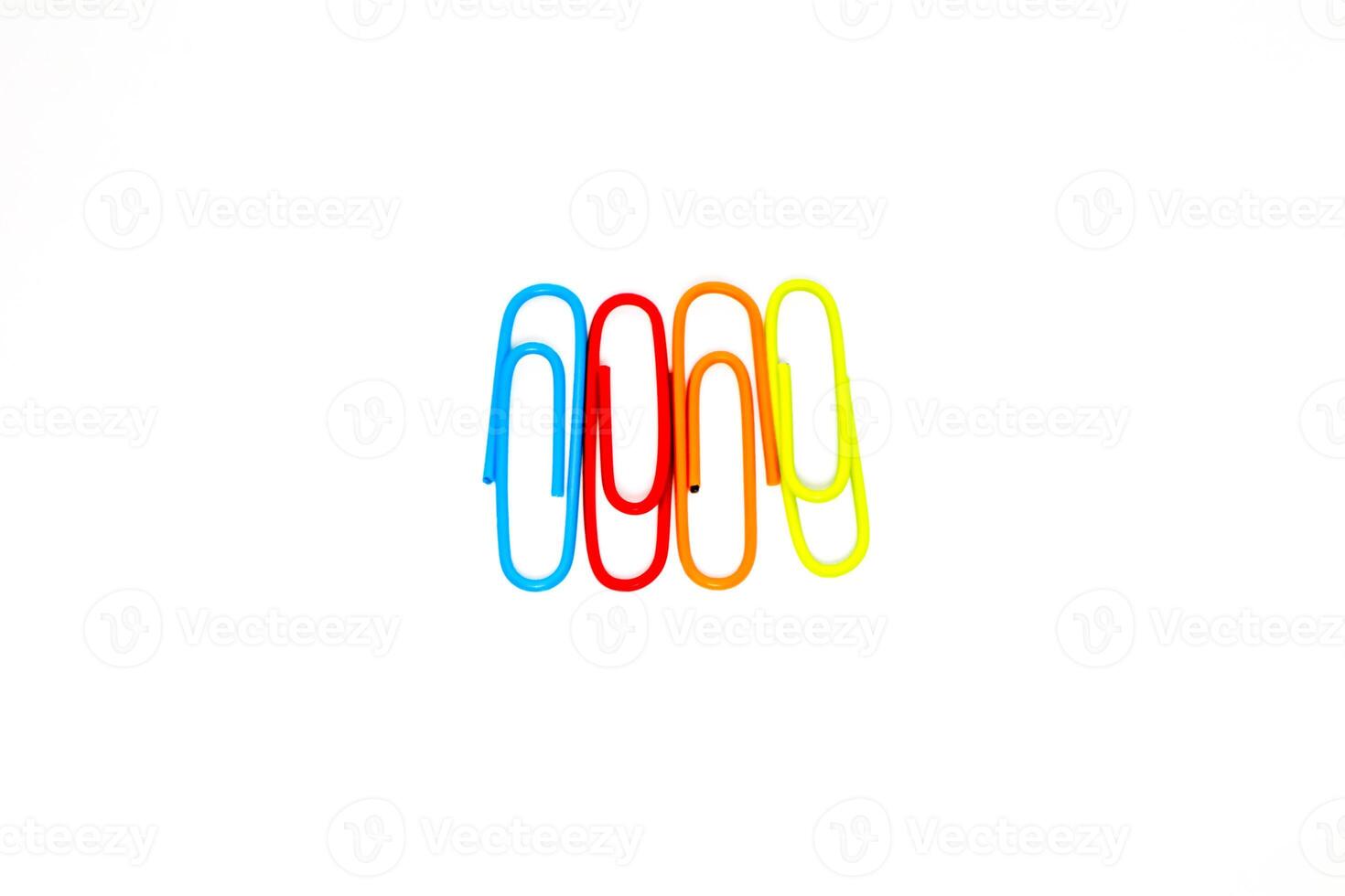 Colorful paper clips arranged in a row on a white background, creative and vibrant office supplies still life photo