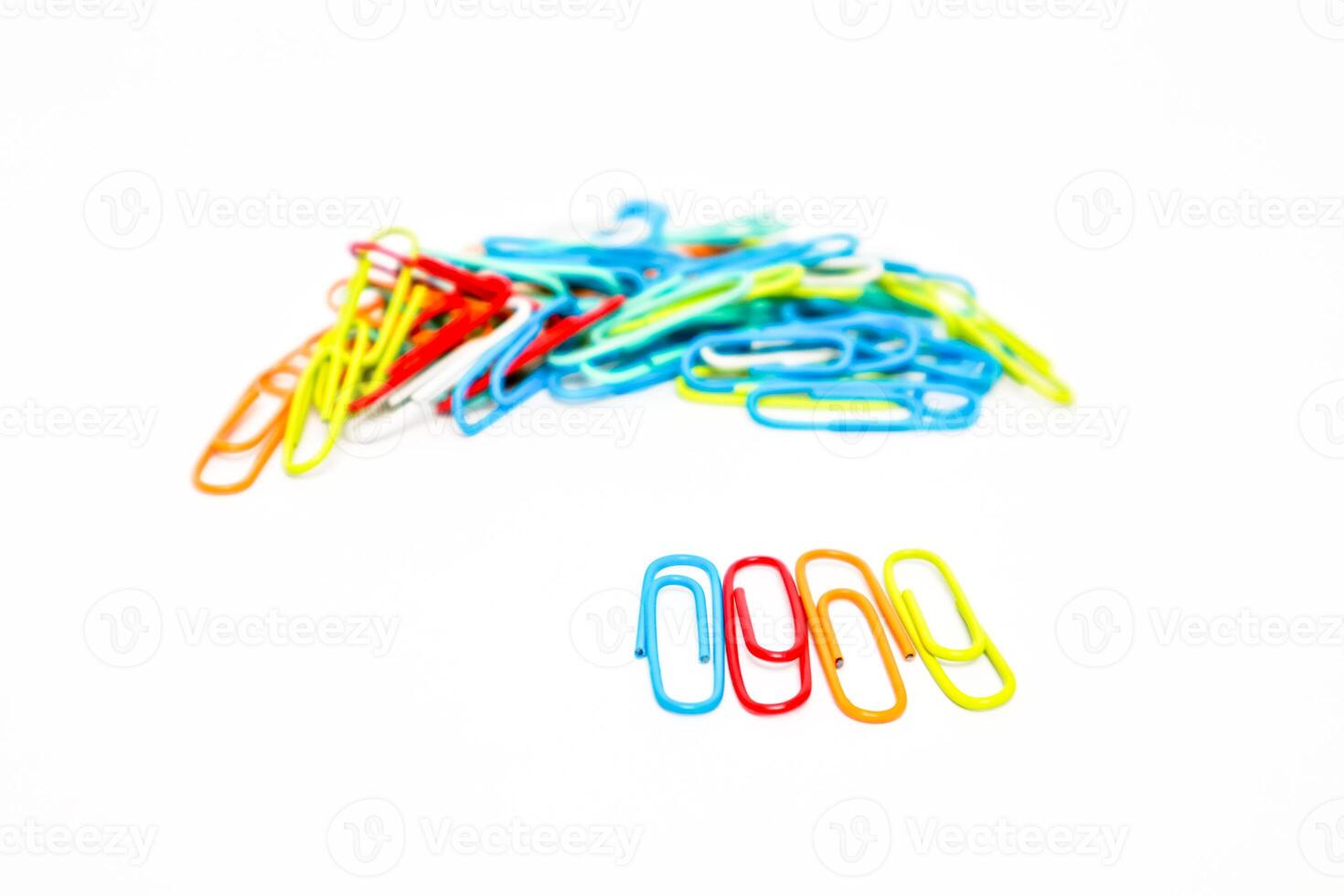 Vibrant paper clips scattered on a clean white background, perfect for office and school themed visuals photo