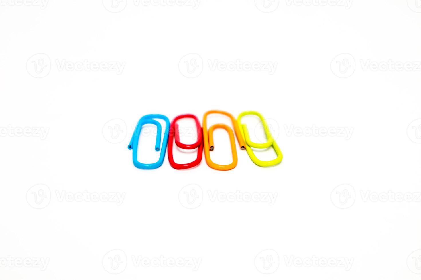 Colorful paper clips isolated on a white background, symbolizing organization and office work photo