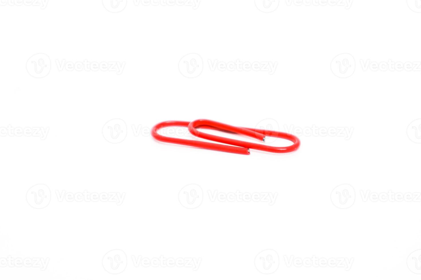 Close-up of a Red Paper Clip on a White Background, Symbolizing Organization and Office Supplies photo