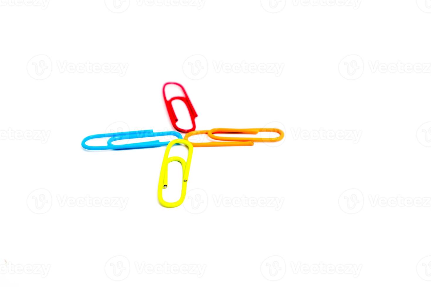 Colorful Paper Clips Arranged in a Cross on a Clean White Background, Isolated photo