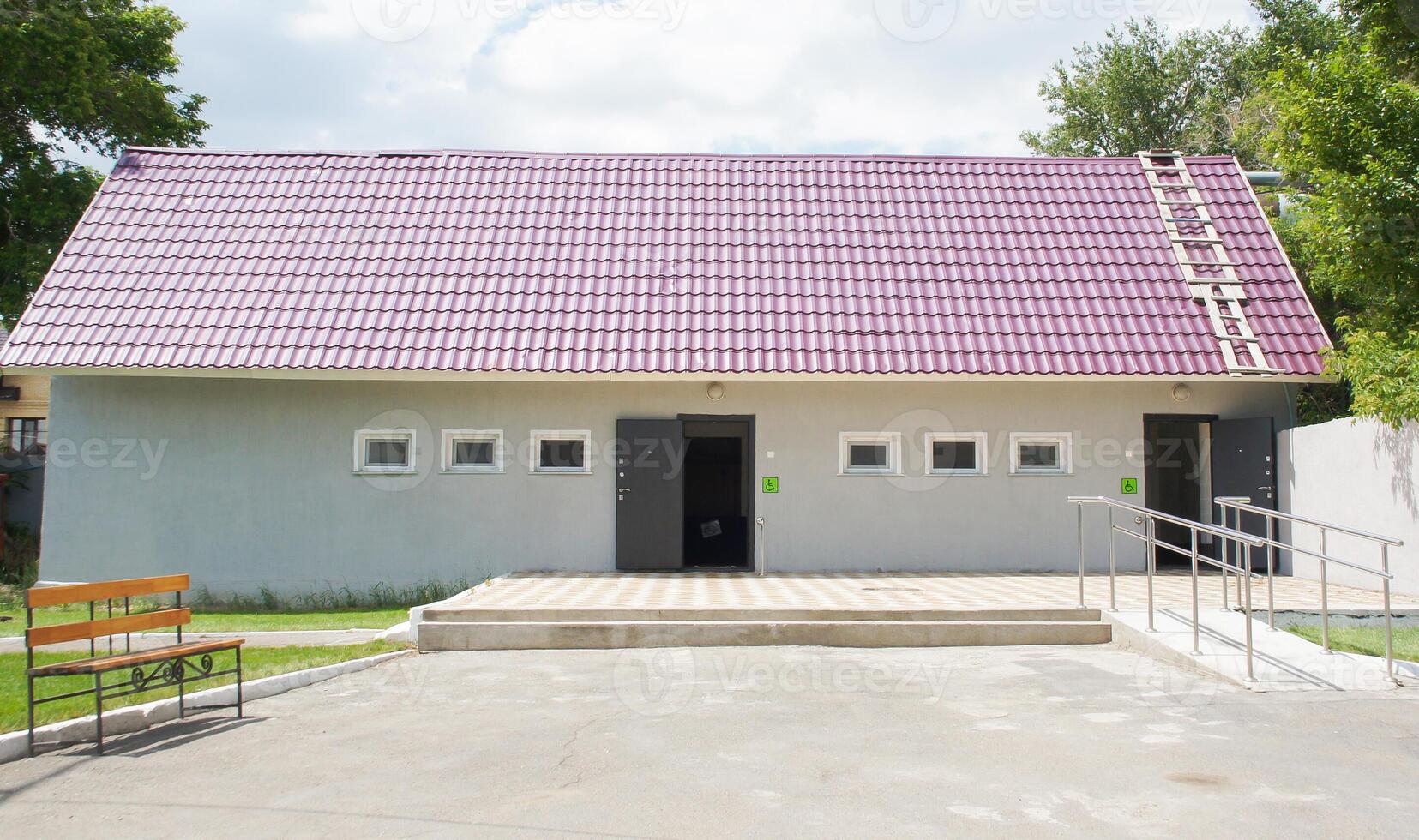 a modern public toilet facility with a clean and accessible design. handicap friendly ramps. Ideal for use in articles about public infrastructure, accessibility, or urban planning photo