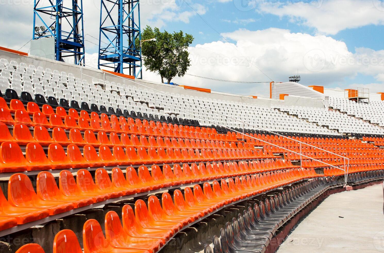a section of a stadium with plastic seats. Ideal for use in articles about sports venues, event planning, or urban infrastructure photo