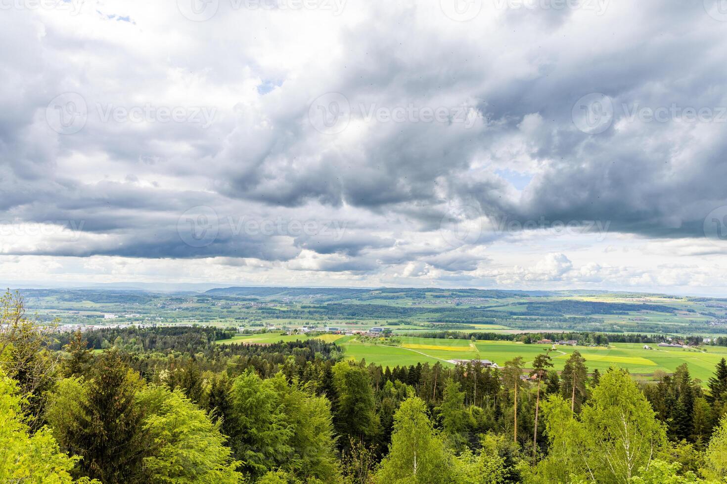 fields village on the hills against a cloudy skyForest Fields Village on Hills under Cloudy Sky photo