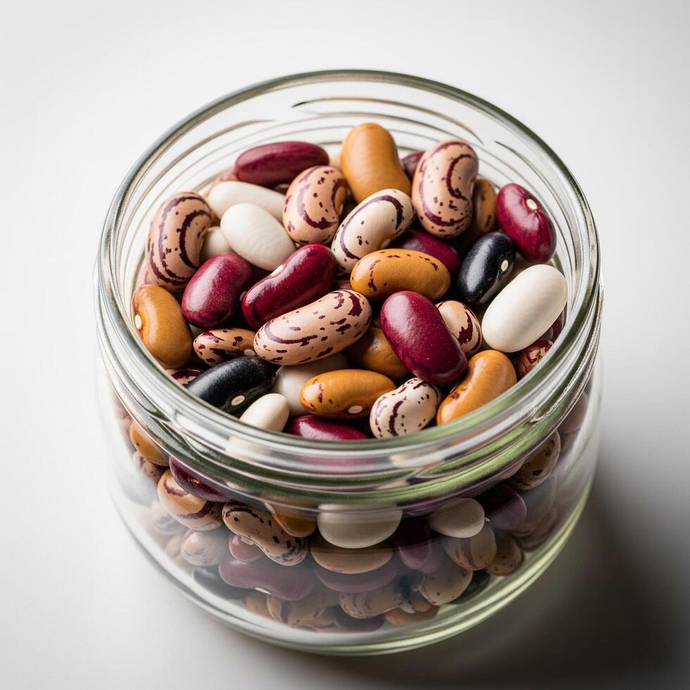 A glass jar filled with beans and other beans photo