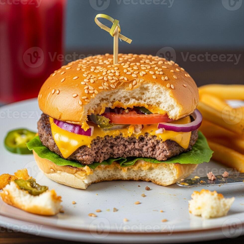 A cheeseburger with cheese, lettuce, tomato and onion on a plate photo