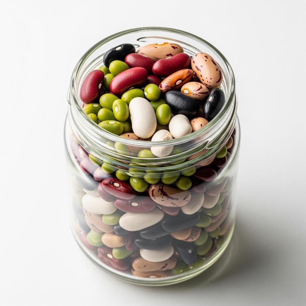 A jar filled with beans and peas on a white background photo