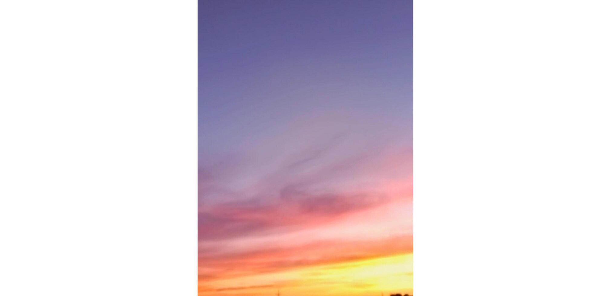 A sunset is shown in the background of a phone case photo