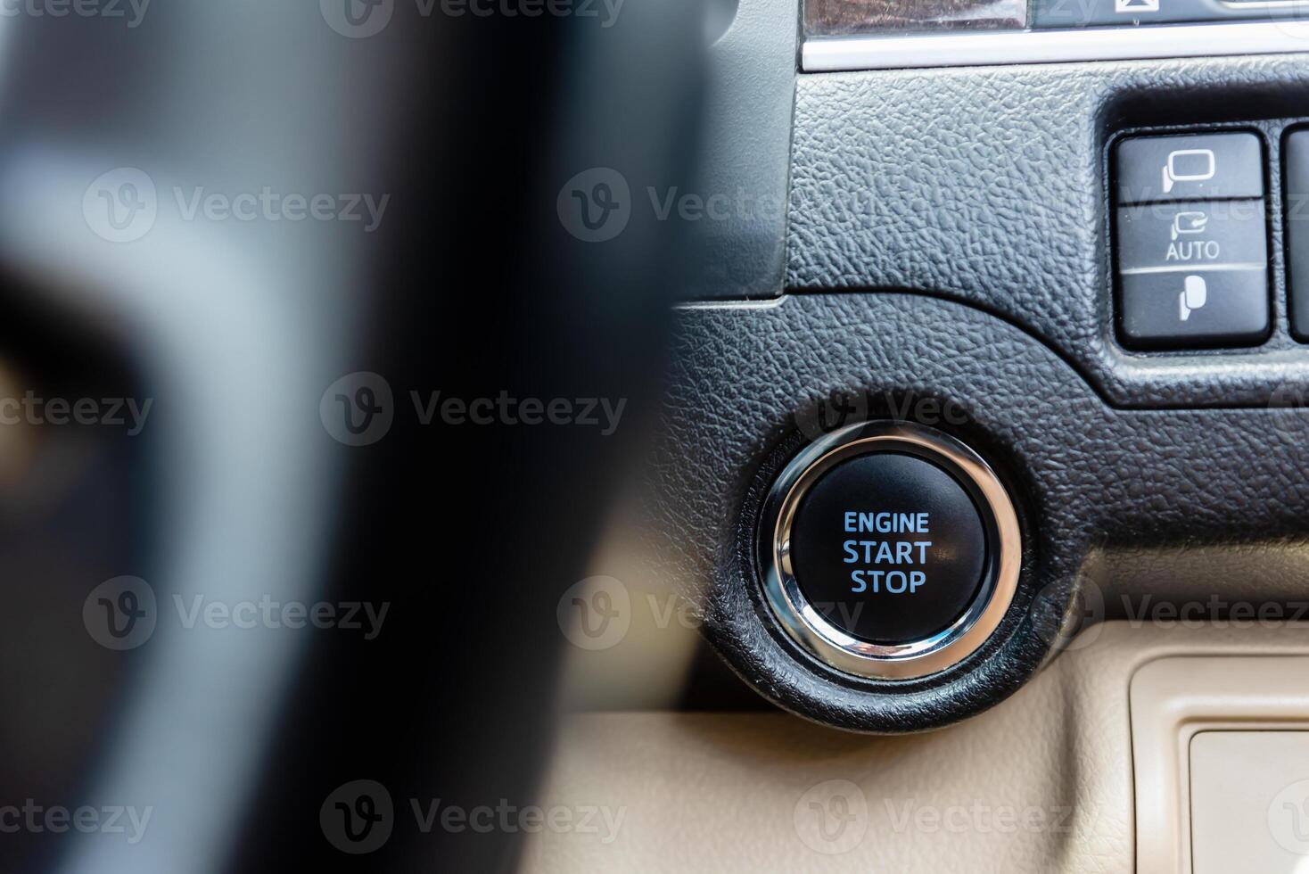 Close up image of start and stop engine botton on car. photo