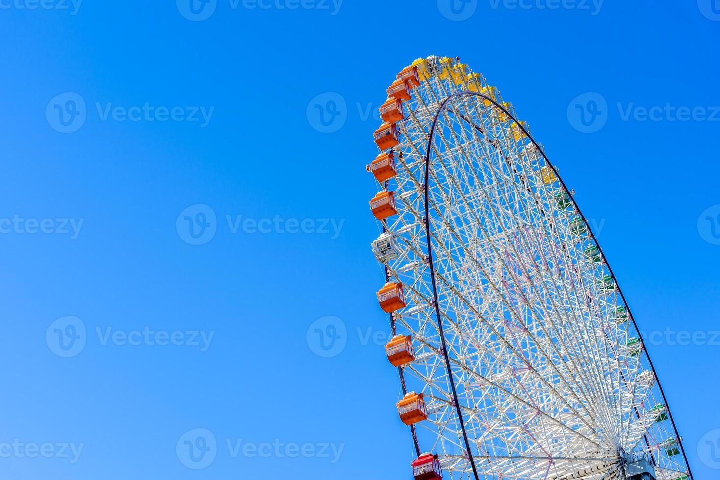 Ferris wheel, colorful big wheel on blue sky. Tempozan ferris wheel Osaka city Japan. photo