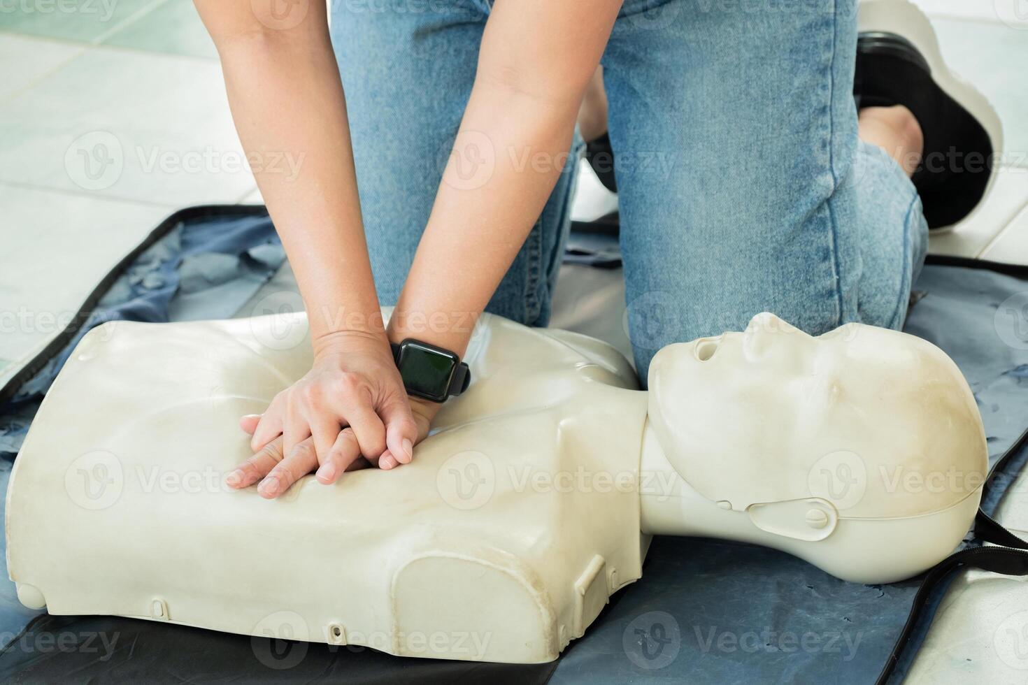 Person performing CPR chest compressions on a training dummy during first aid training. Concept for emergency response, lifesaving skills, or CPR certification photo