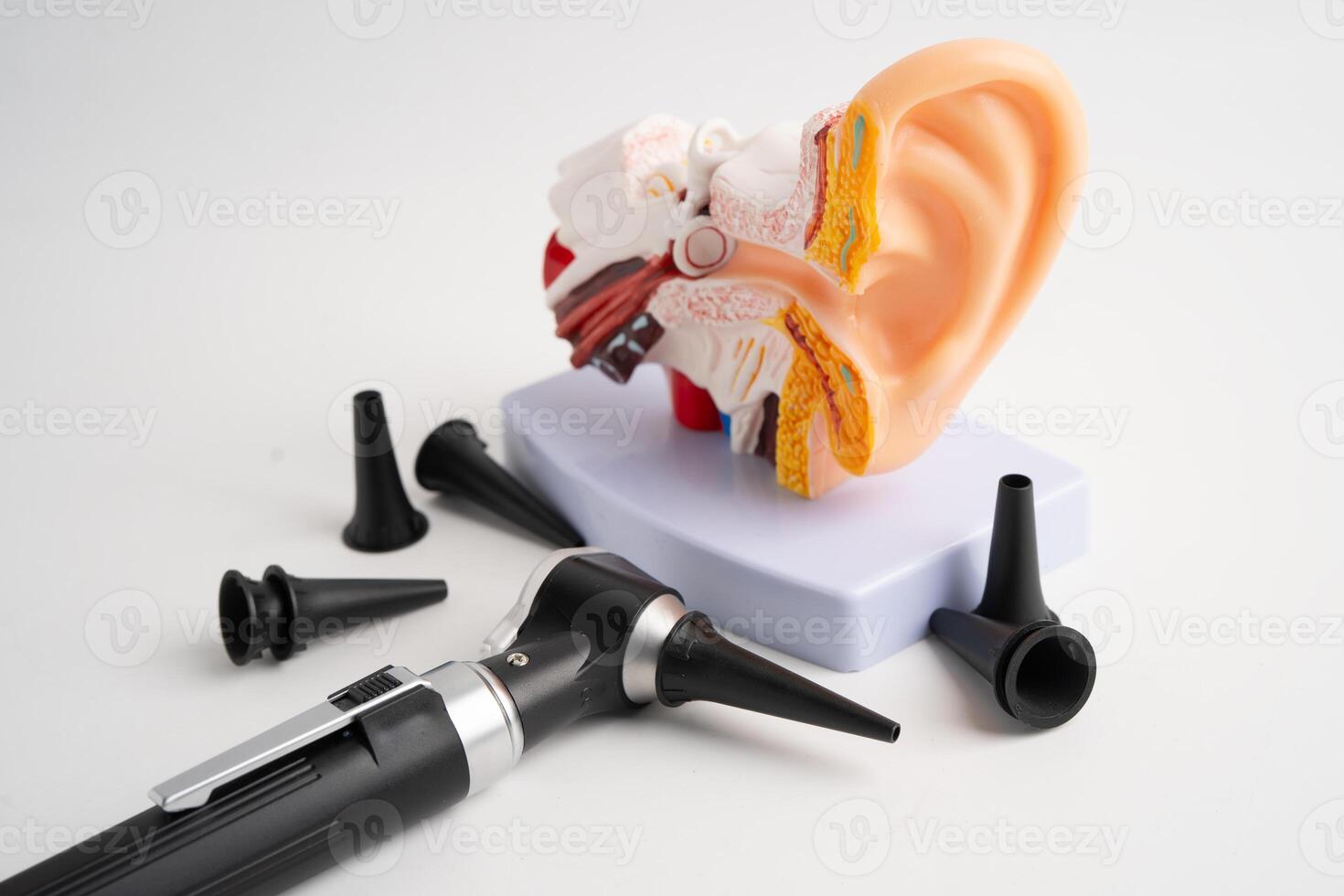 Otoscope isolated on white background for otolaryngologist or ENT physician doctor examining senior patient ear, hearing loss problem. photo