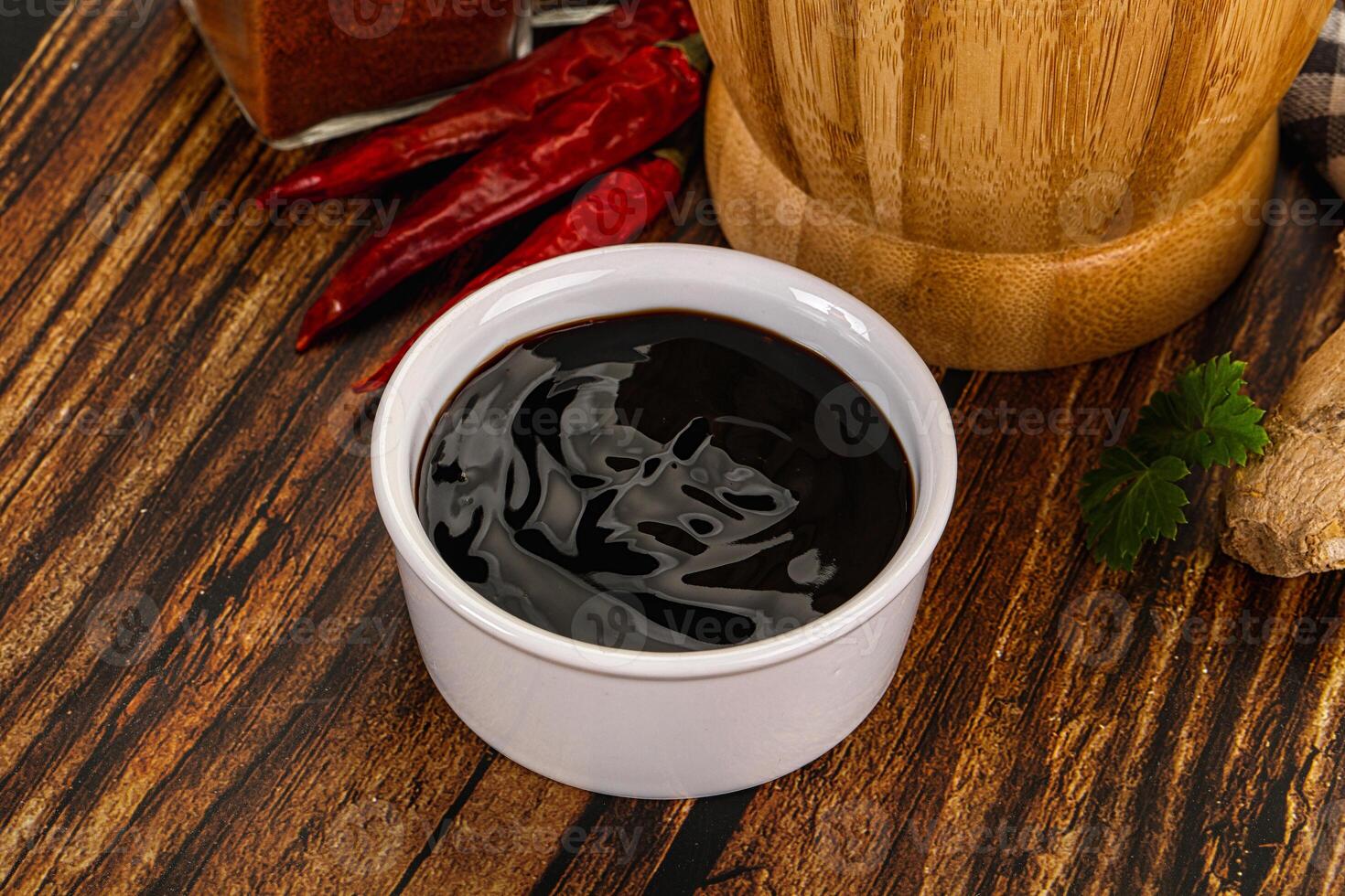 A cup of black liquid next to a spice grinder photo