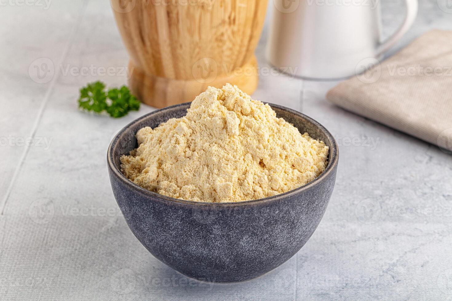A bowl of food next to a wooden spoon photo