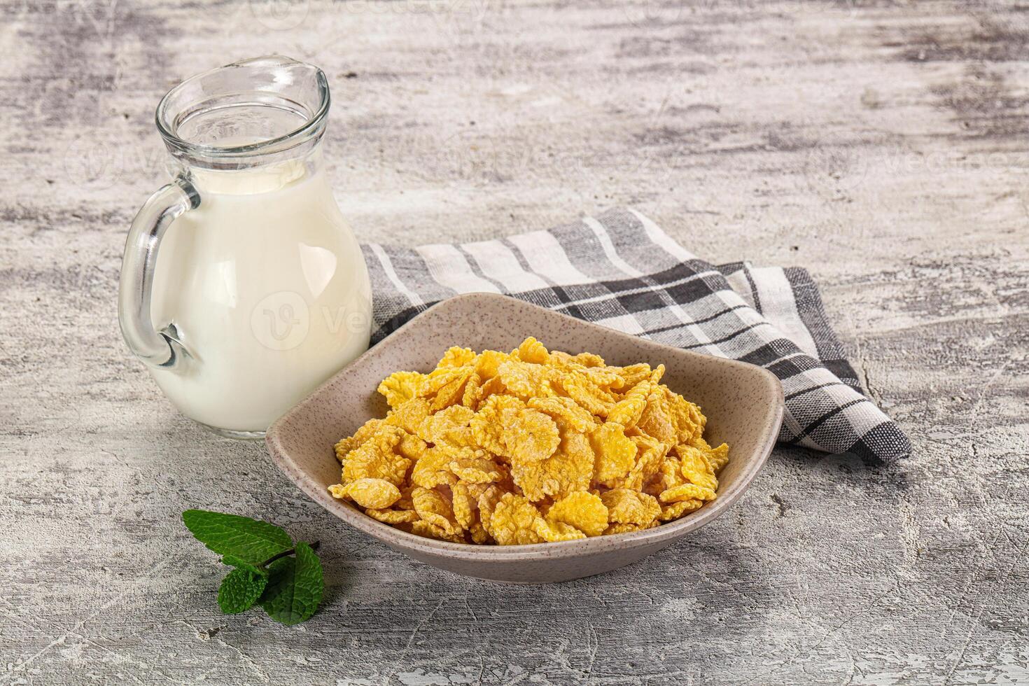 Corn flakes and milk on a wooden table - stock photo - images