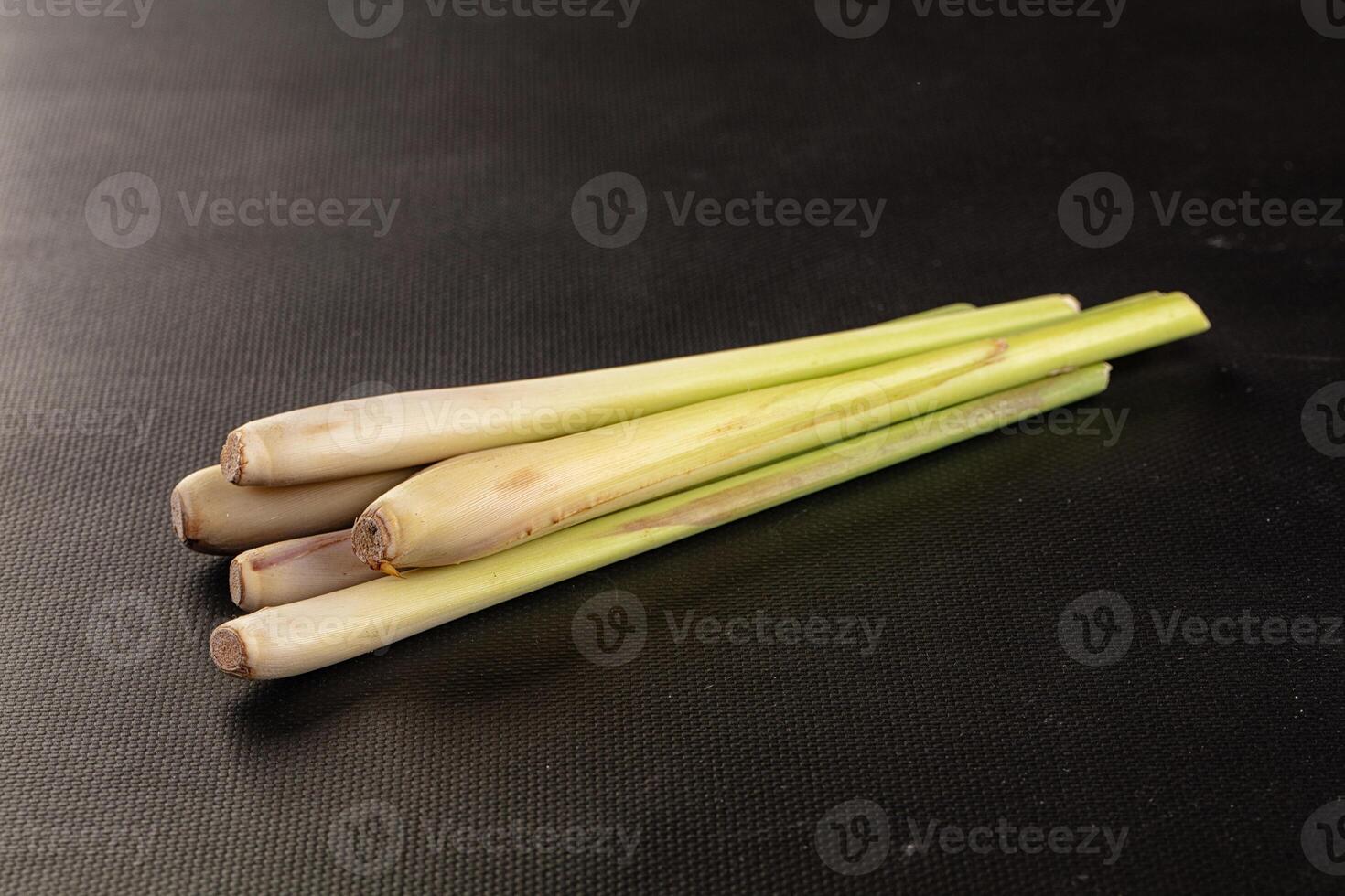 Three long, green stalks of lemongrass photo