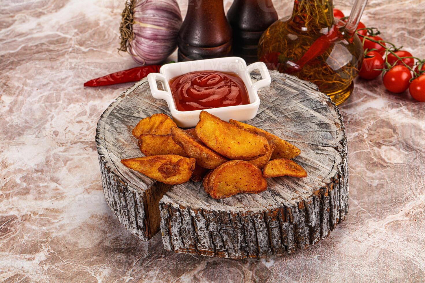 A plate with some chips and ketchup on it photo