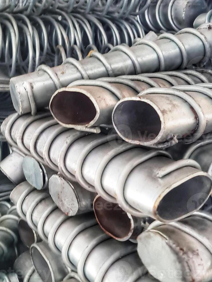 Stacked Metal Tubing with Spiral Wraps Close-up photo