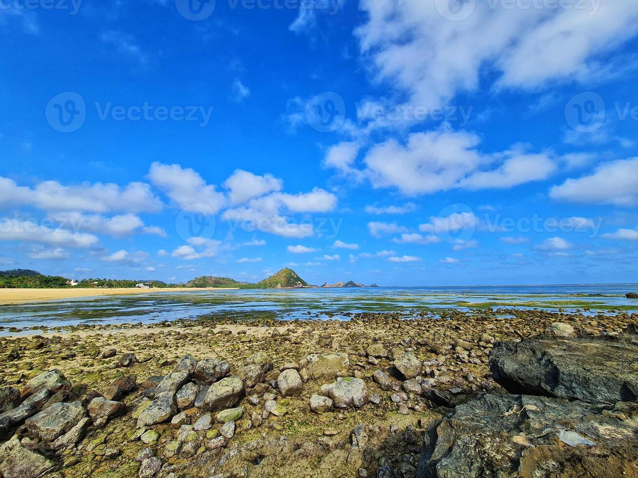 Coastal Landscape with Rocks and Blue Sky at Tropical Beach photo