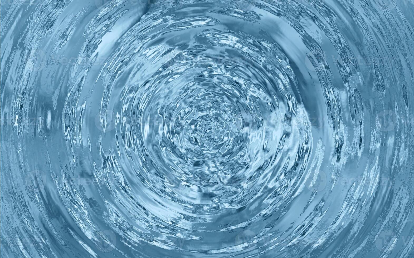 Vortex of swirling clear water with reflections and turbulence captured in a top-down motion blur spiral pattern photo