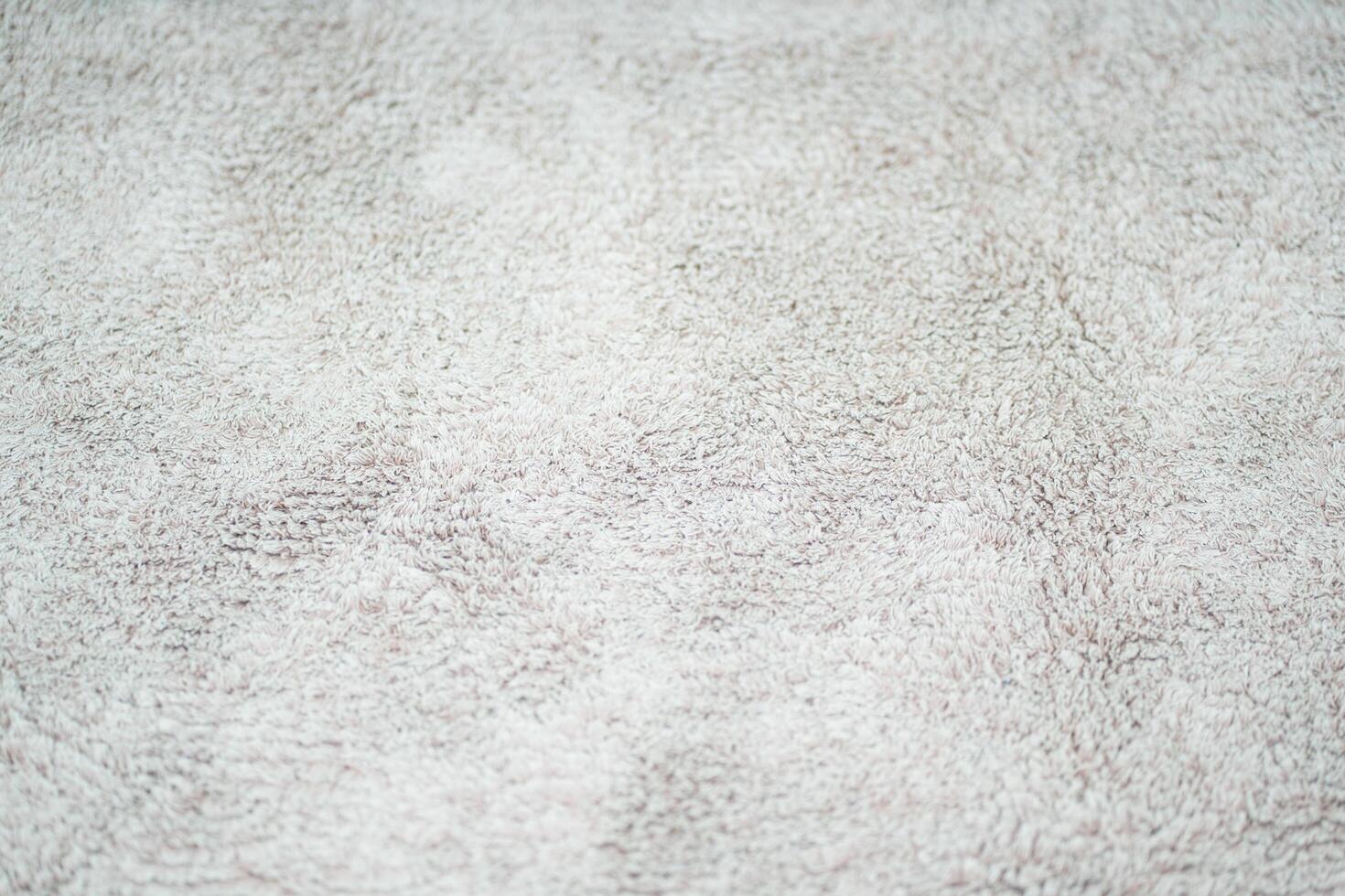 The texture of the fabric on the carpet is light gray photo