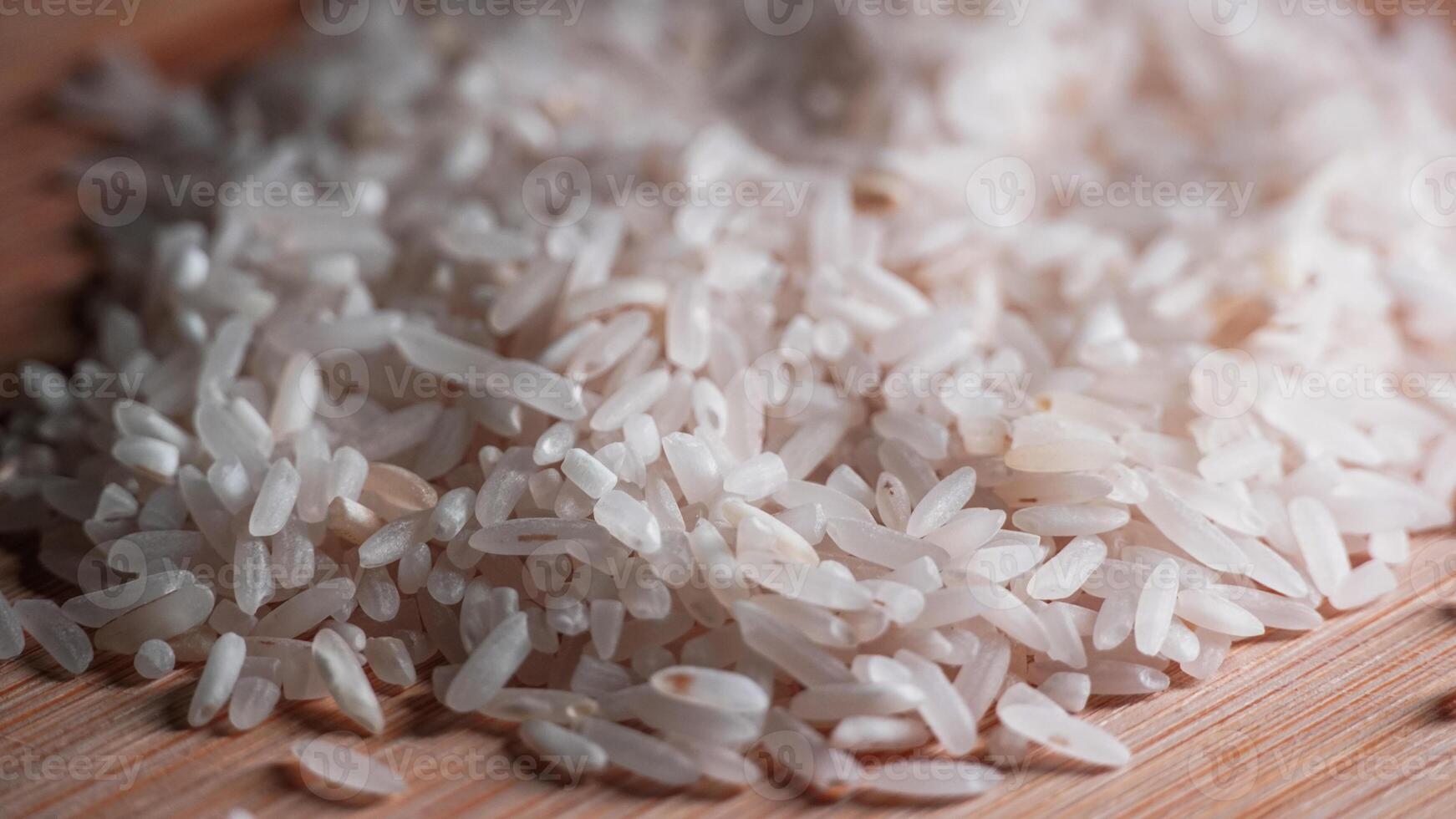 closeup of white rice on wooden table photo