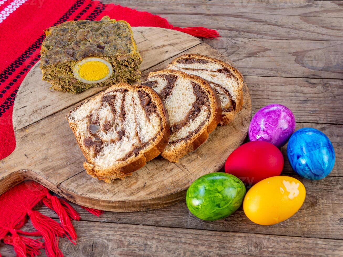 A wooden cutting board with a slice of bread and eggs photo
