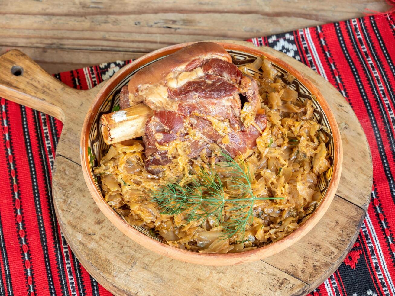 A bowl of food with meat and vegetables on a table photo