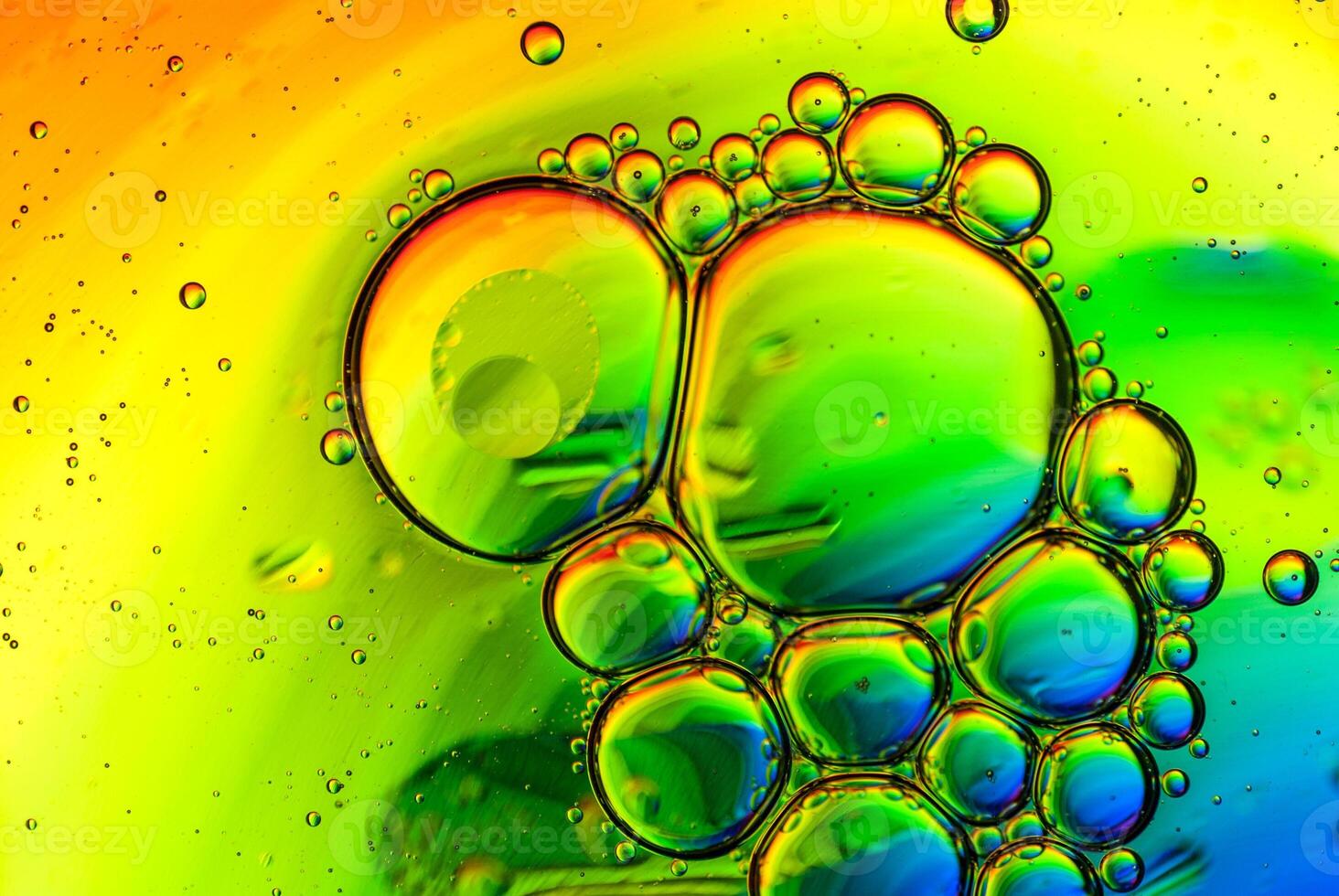Oil and water bubbles in a rainbow colored background photo