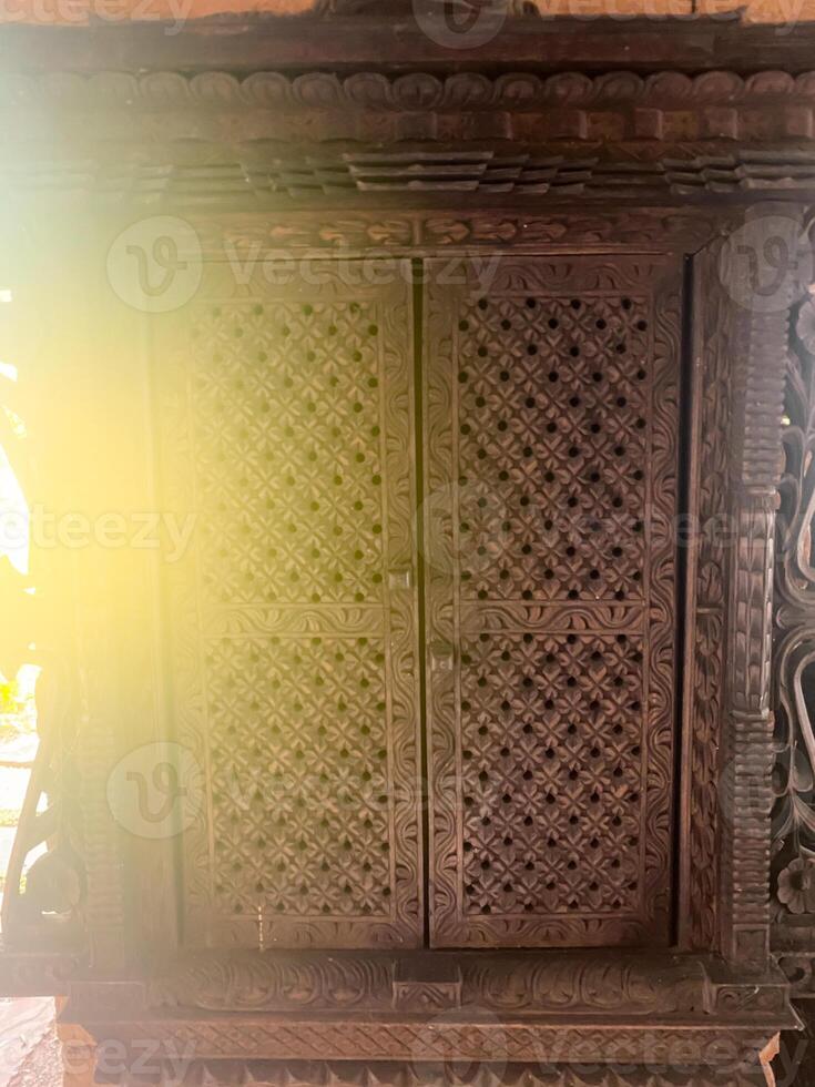 A wooden door with a sun shining through it photo