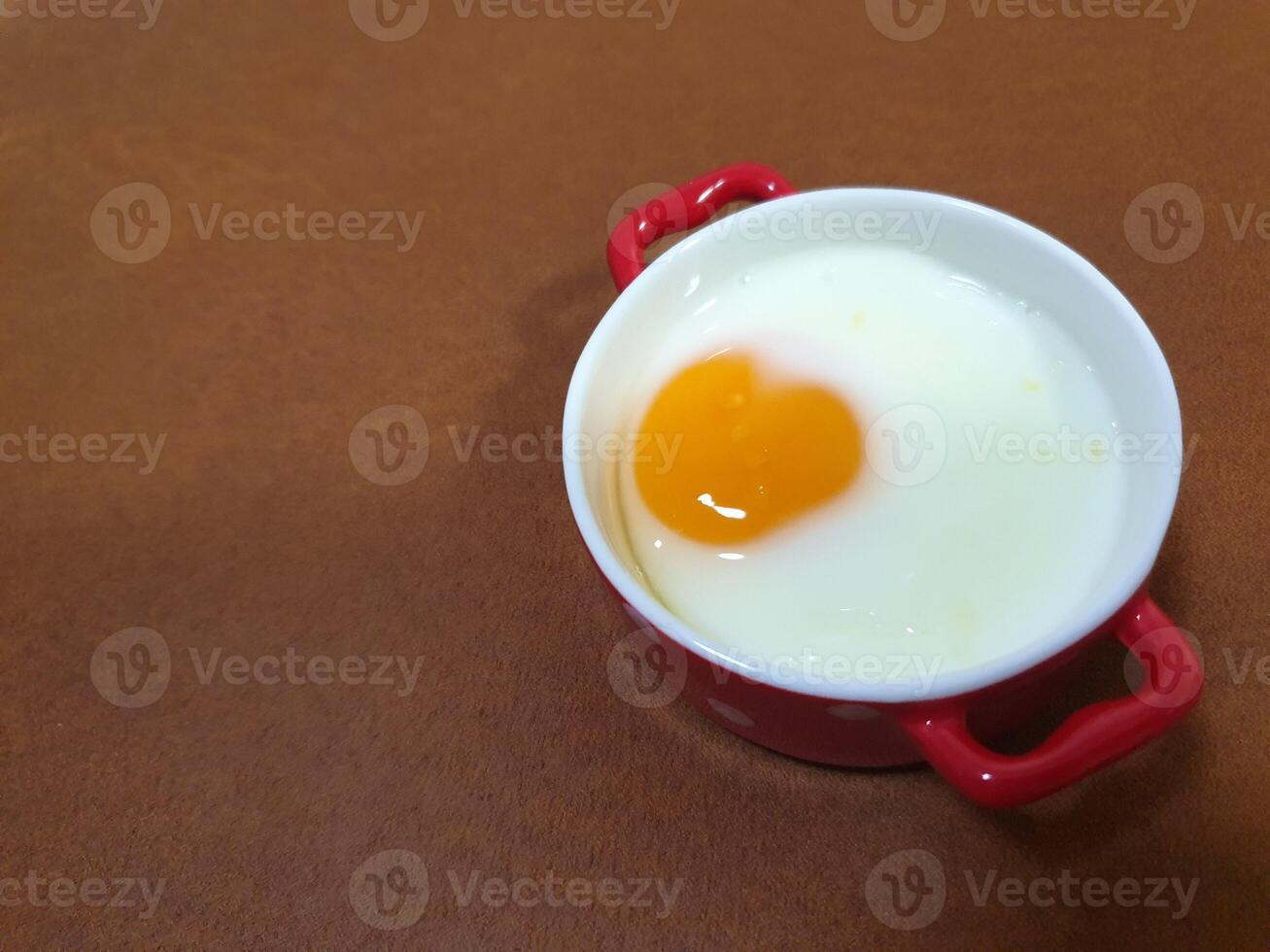 A small bowl with an egg in it photo