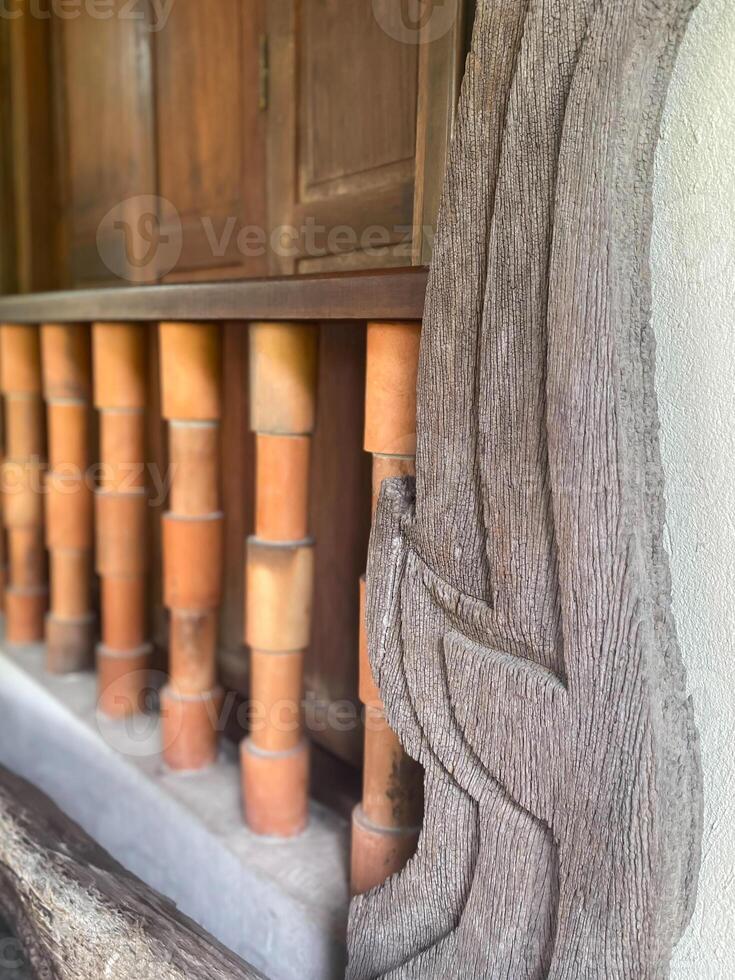A wooden railing with a carved design on it photo