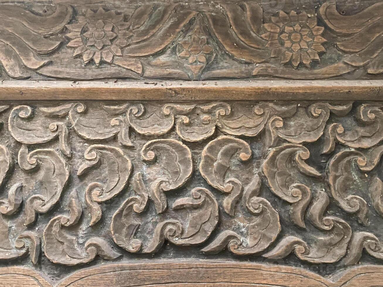 An old wooden panel with intricate designs photo