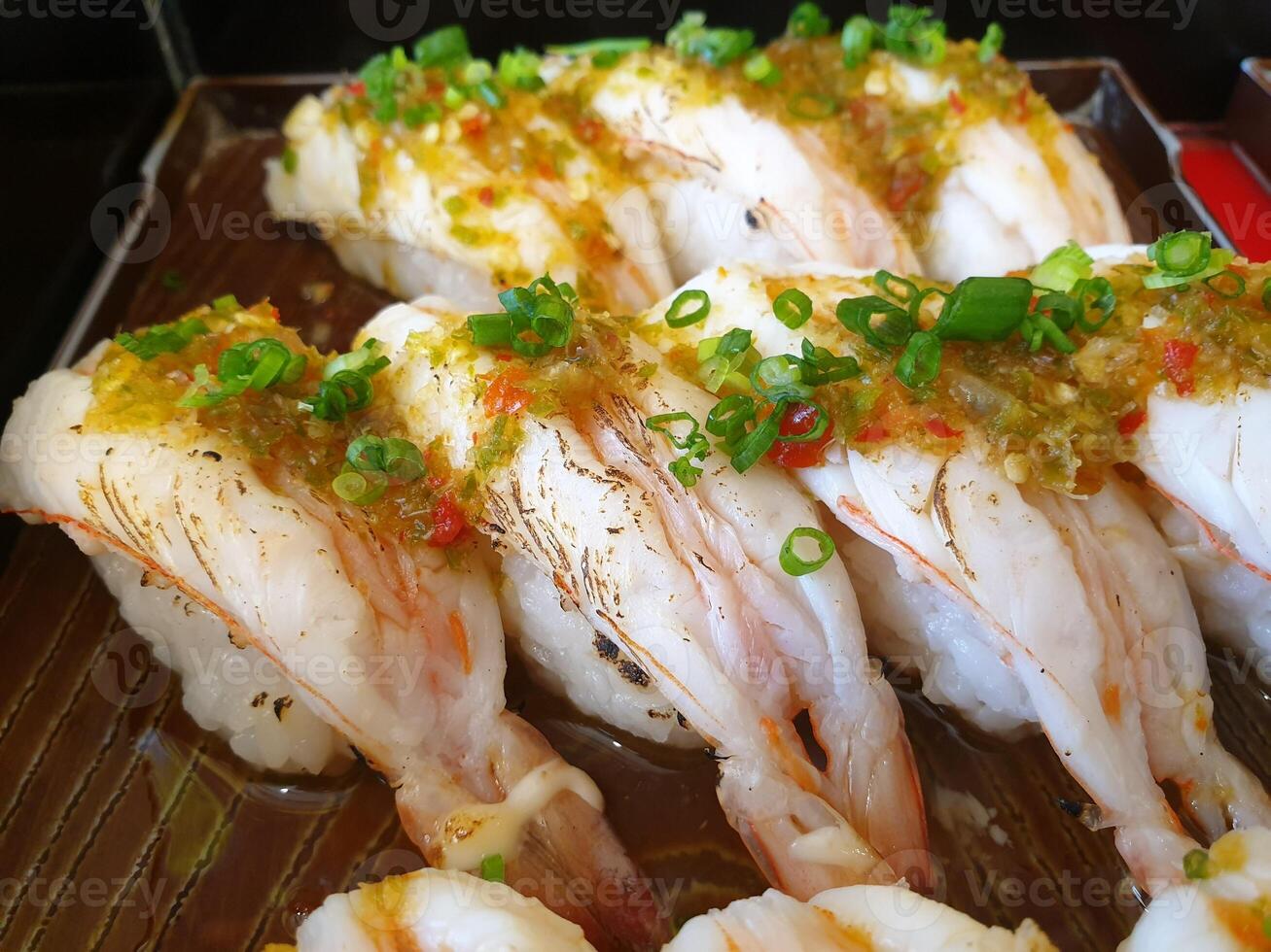 A tray of shrimp with green onions photo